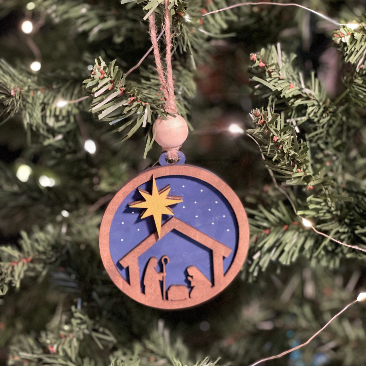 Christmas ornament featuring a handcrafted nativity scene.