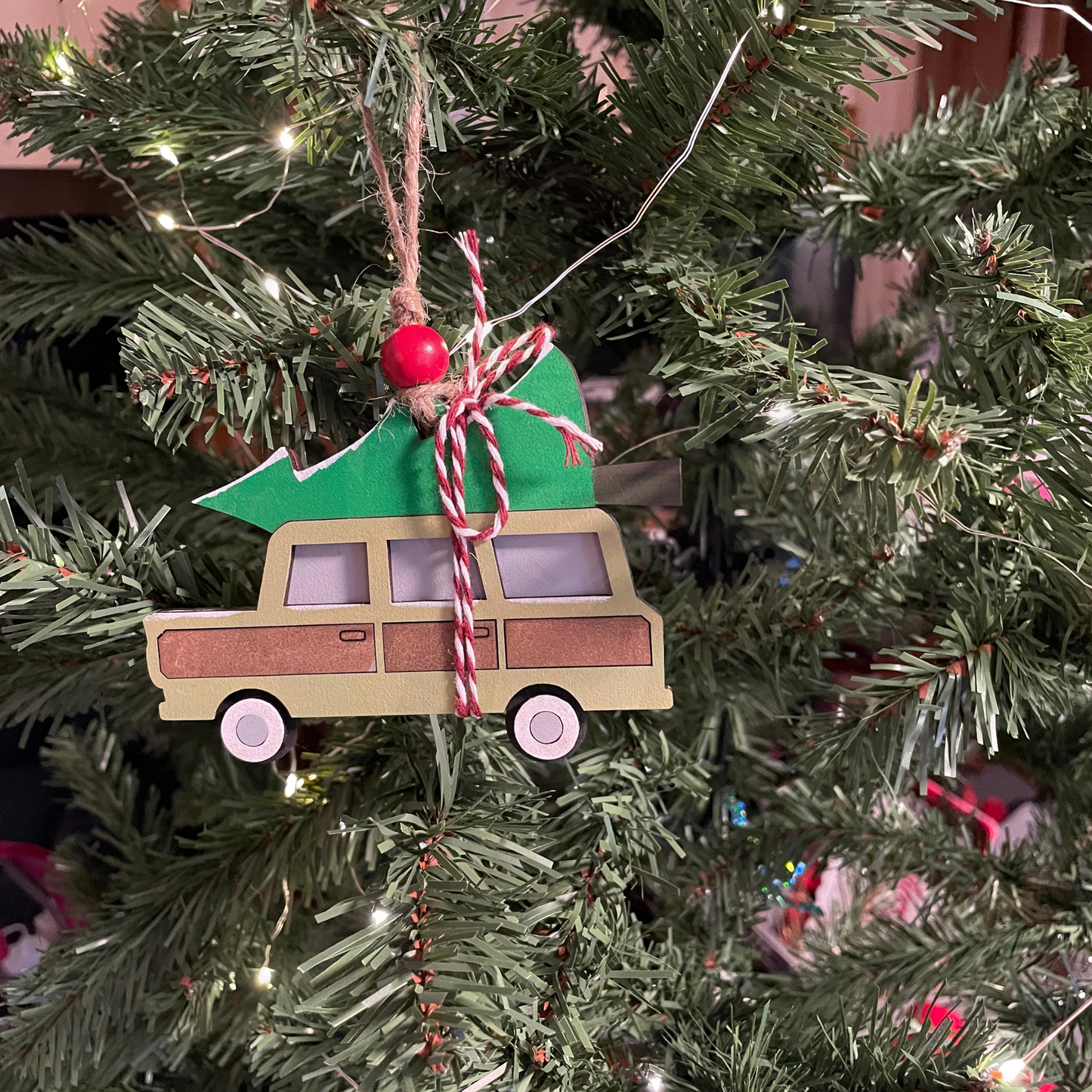 Family Christmas Truck Ornament on Christmas tree with festive design and vibrant colors.