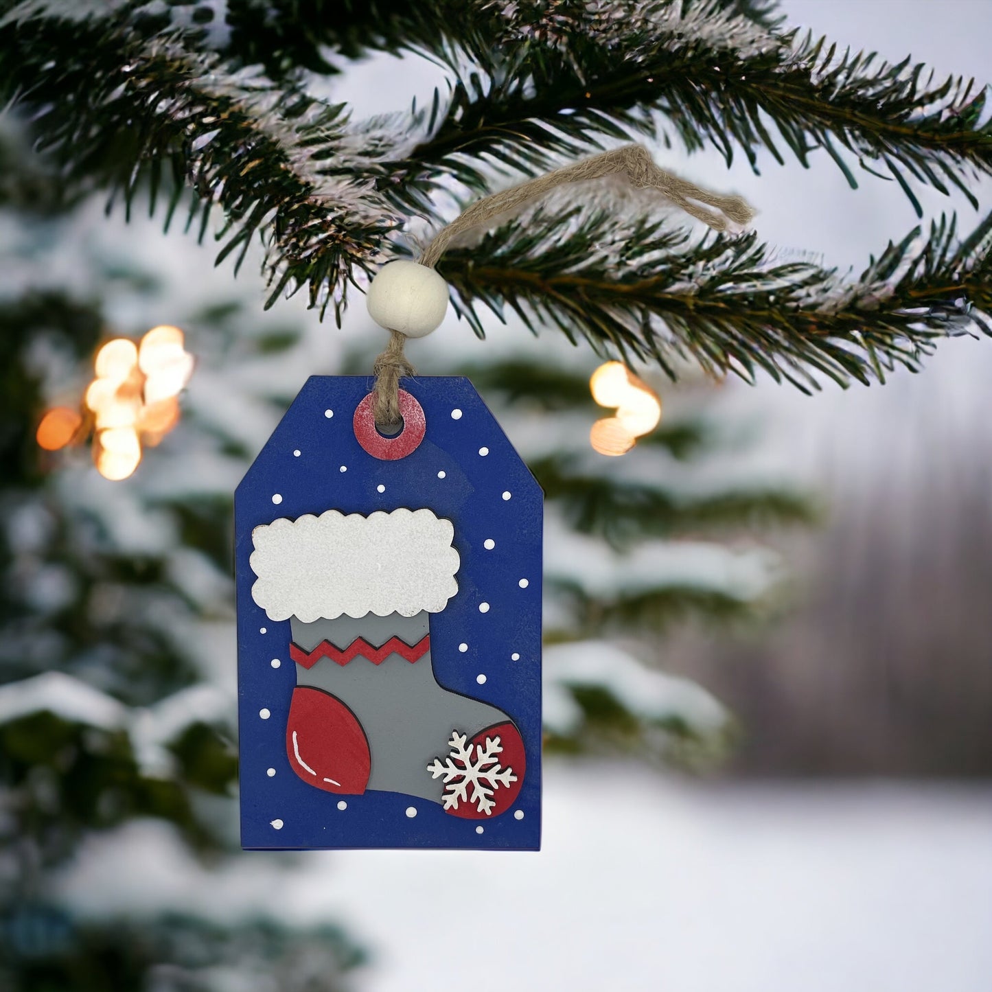 Christmas ornament featuring a snowflake stocking, hand-sculpted wood with money/gift card pocket.