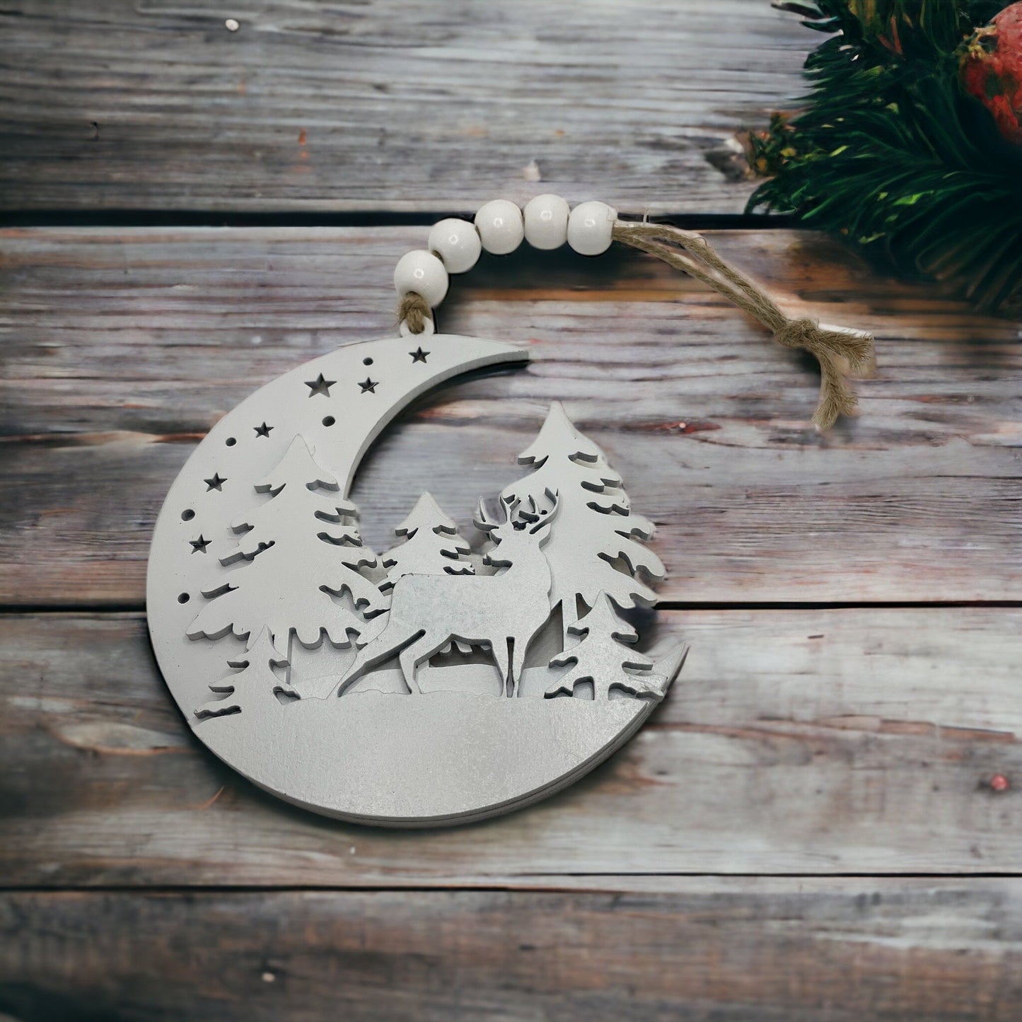 Moon Woodland Christmas Ornament with deer and trees design.