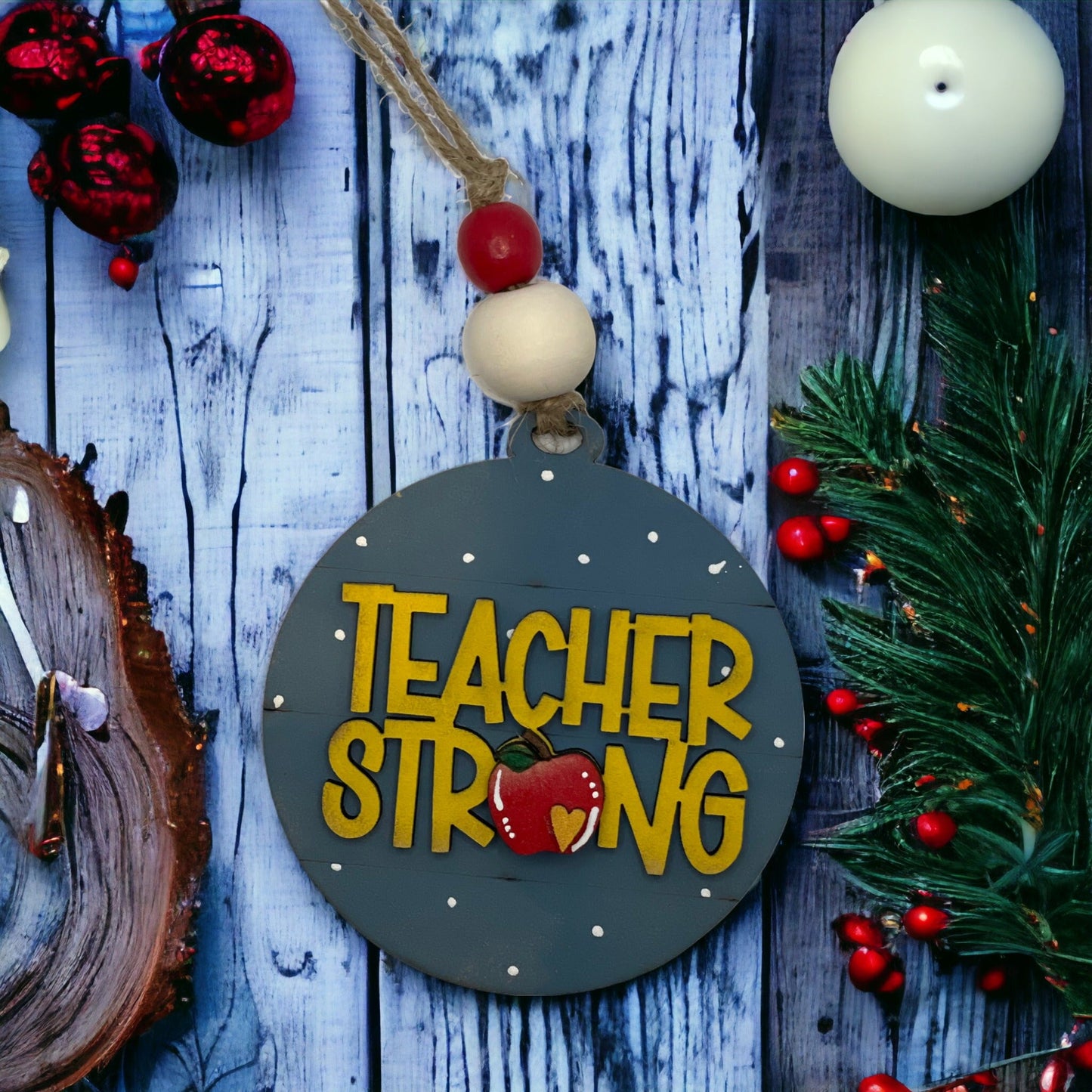 Christmas ornament with "Teacher Strong" text, handcrafted from quality wood, ideal holiday gift.