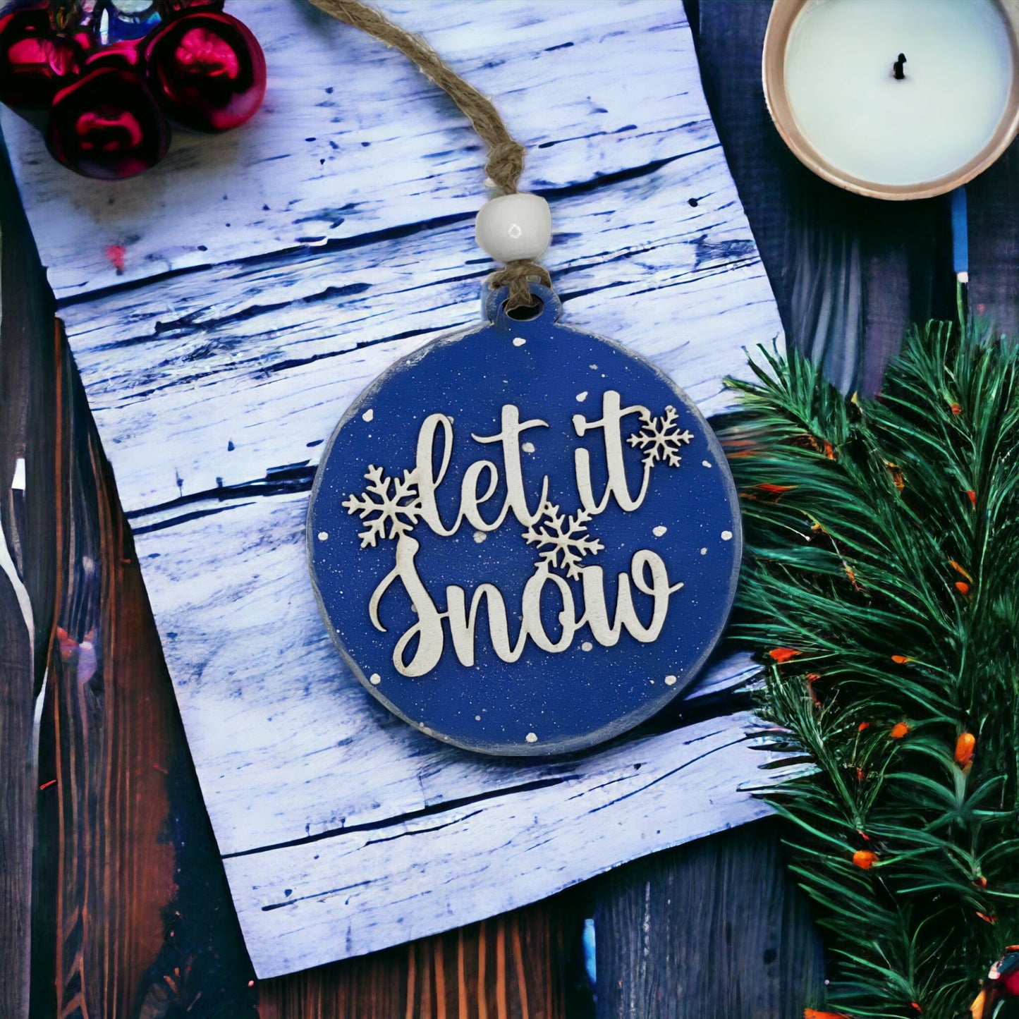 Handcrafted round Christmas ornament with "Let it Snow" design, made from quality wood.