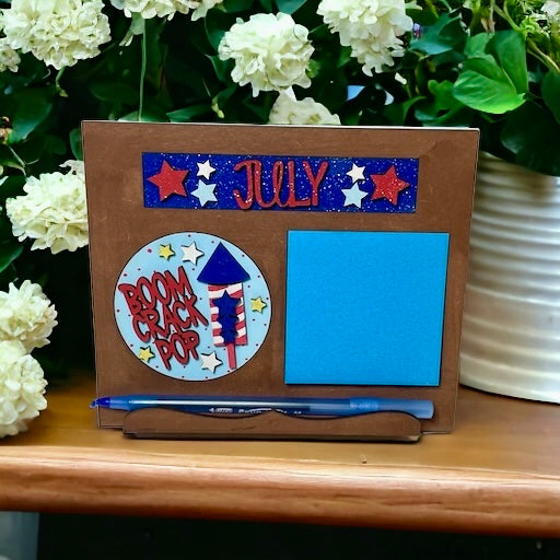 Interchangeable Seasonal Standing Note Holder Sign Base with July decorations and pen holder.