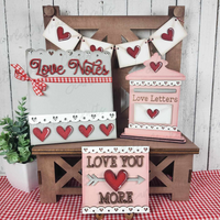 Valentine's Day tiered tray set with love-themed decor including "Love Notes" and "Love Letters" signs, hand-painted in vibrant colors.