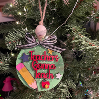 Hand-painted wooden Christmas ornament with Teachers Gonna Teach lettering, pencil, apple, stars, and plaid bow on tree