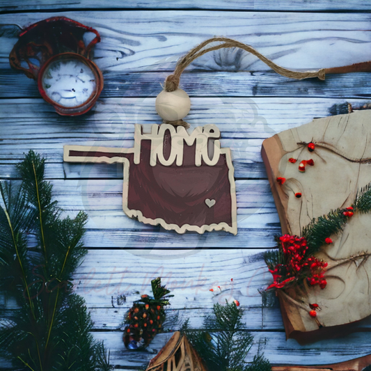 Maroon and creme hand-painted wooden Oklahoma Christmas ornament with "Home" lettering and natural twine hanger
