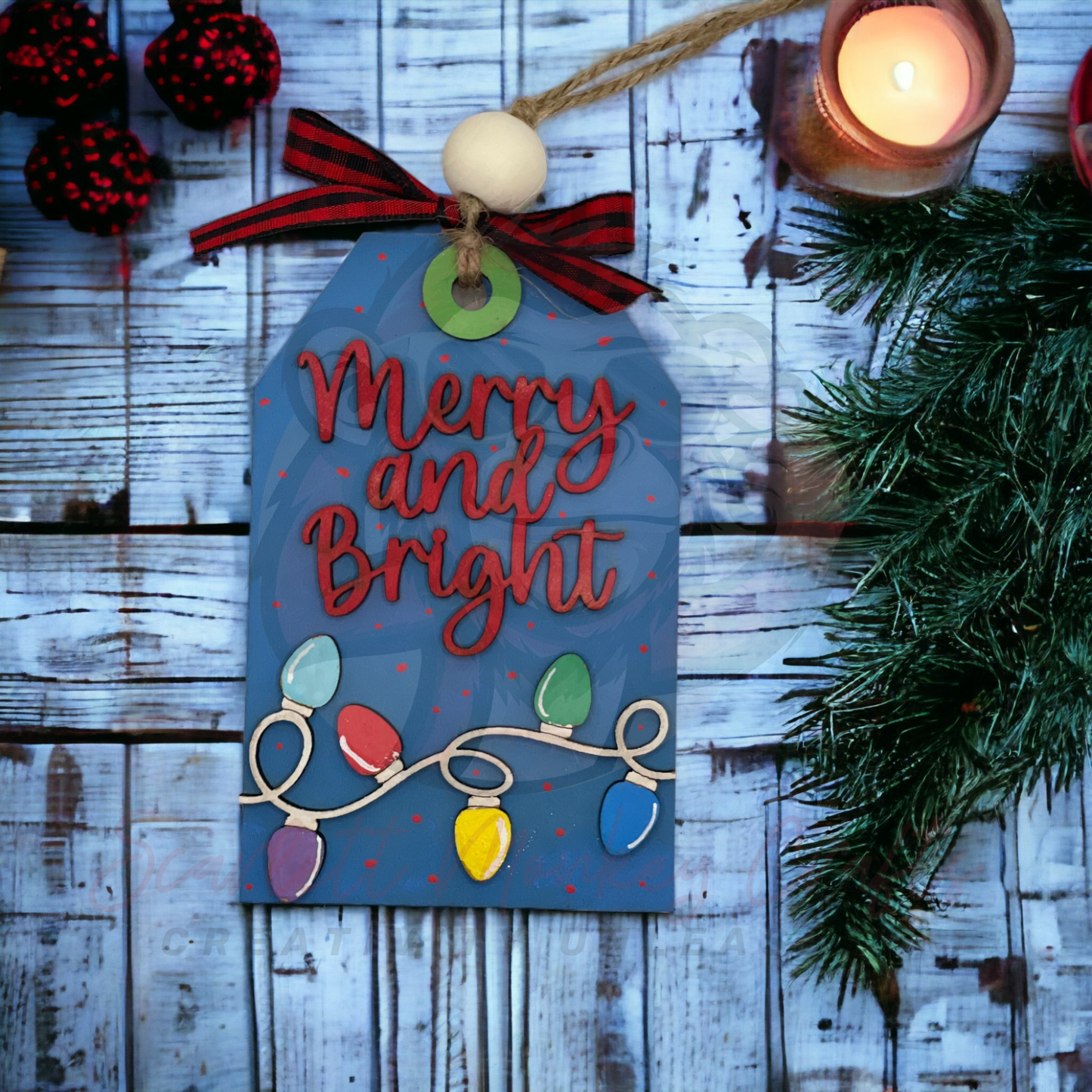 Hand-painted "Merry and Bright" Christmas ornament with colorful light design and gift card holder, hanging with natural twine and bead.