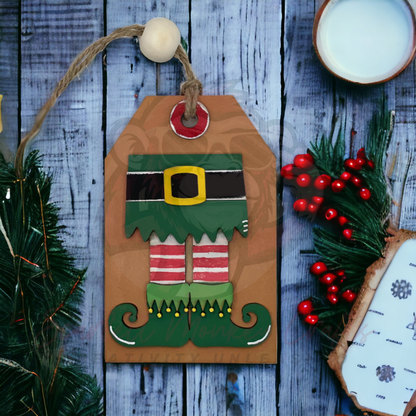 Hand-painted elf legs Christmas ornament with striped stockings and curled shoes, doubles as a gift card holder with natural twine hanger.